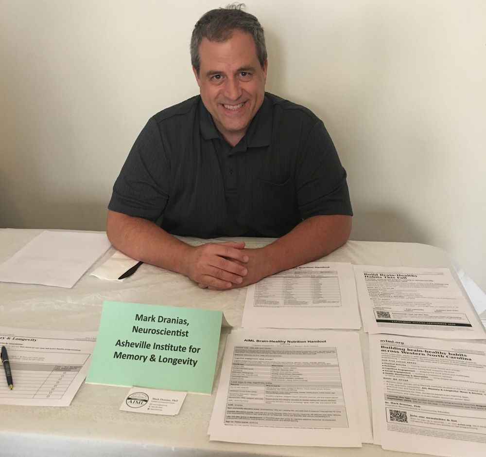 Dr. Mark Dranias at the AIML information table with brain-healthy nutrition handouts